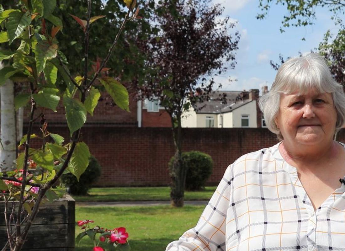 Marlene Garnett smiling in her lovely garden