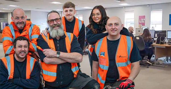 repairs team posing for a photo with the call centre in the background