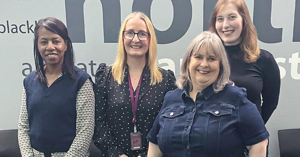 the money matters team posing for a photo in reception