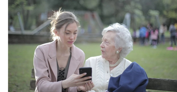 a young woman showing an older woman something on her phone