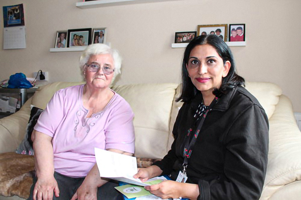 naila sitting with a tenant discussing energy advice