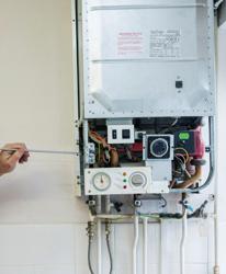 An Image Of Someone Carrying Out A Repair To A Boiler