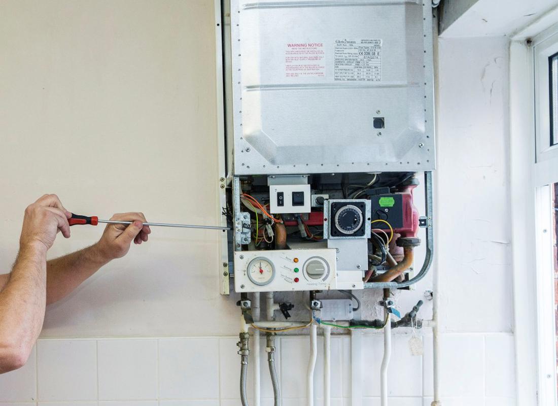 An Image Of Someone Carrying Out A Repair To A Boiler