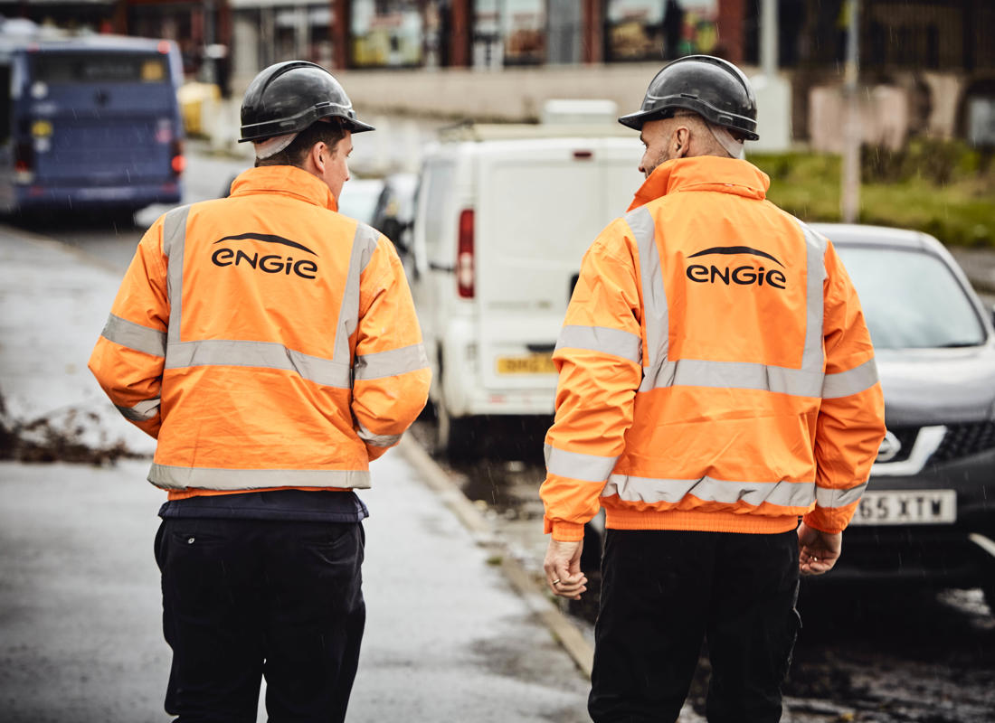 two members of engie staff walking down the street with their protective gear on