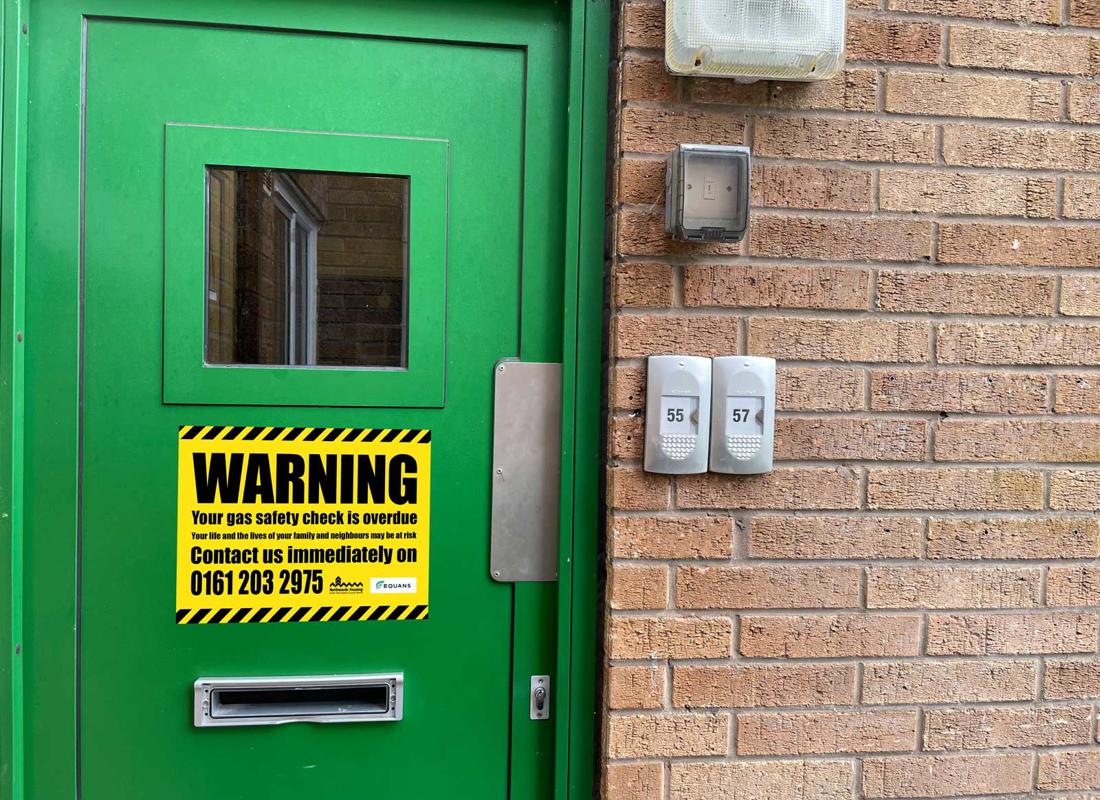 a locked door with a large warning sign on it