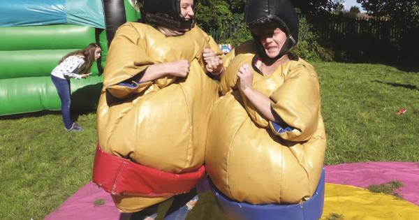 Two Residents Enjoying Fun In A Sumo Suit At One Of Our Fun Day Events